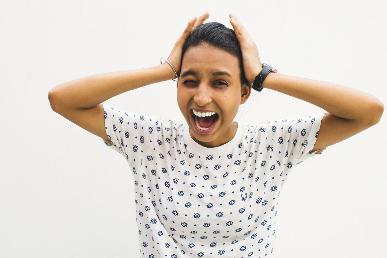 woman holding head in pain